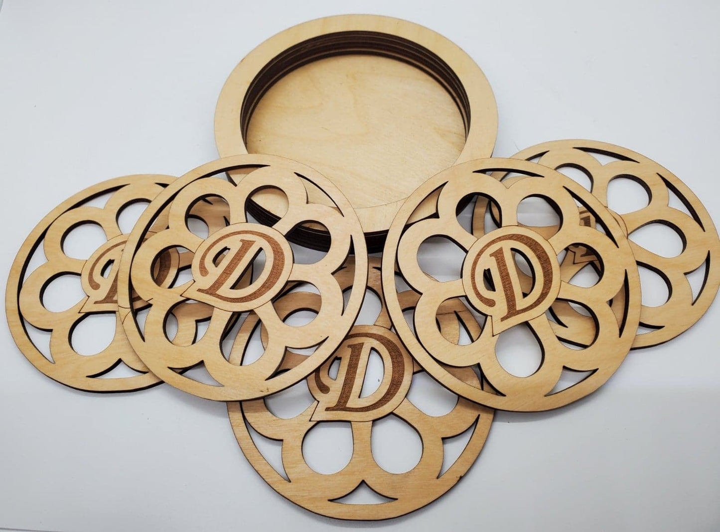 wooden coasters laser cut in sunflower design and monogram with holder in natural finish