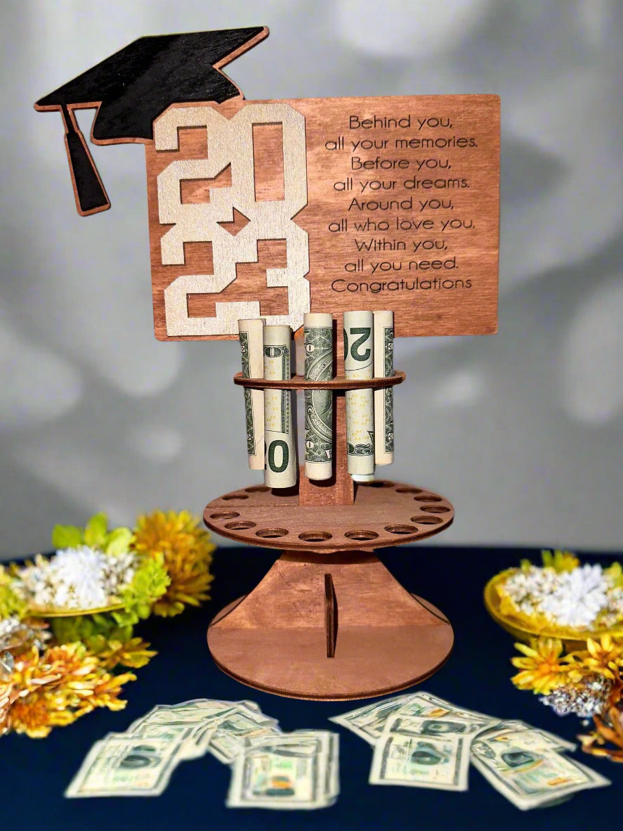 Gift money holder designed after a tiered cake, 25 slots hold rolled money bills.